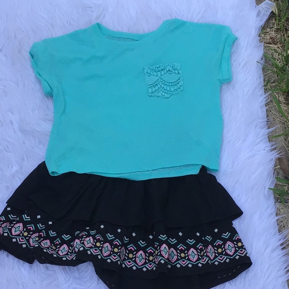 A set of a crop top and a mini skirt